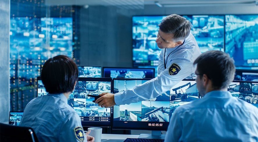 Security operators monitoring CCTV feeds in a control room